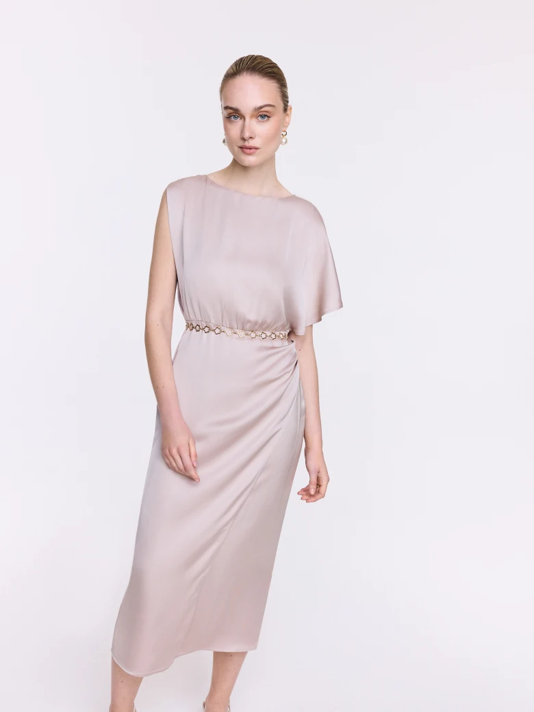 A glamorous dress with an asymmetrical sleeve