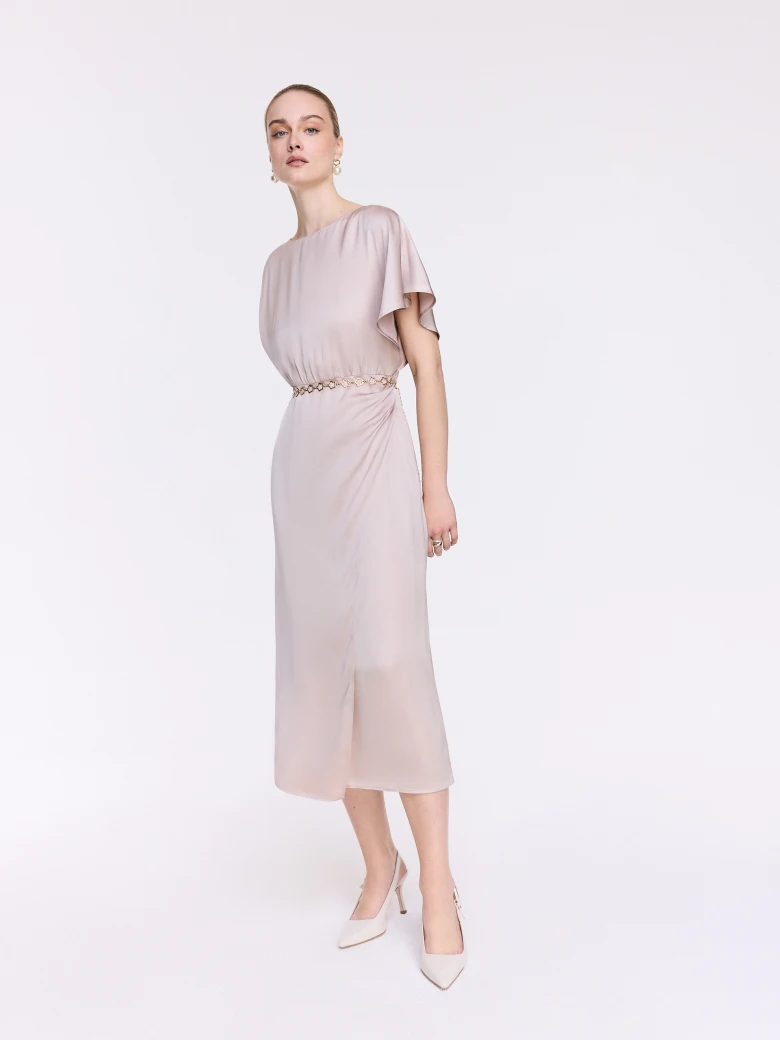 A glamorous dress with an asymmetrical sleeve