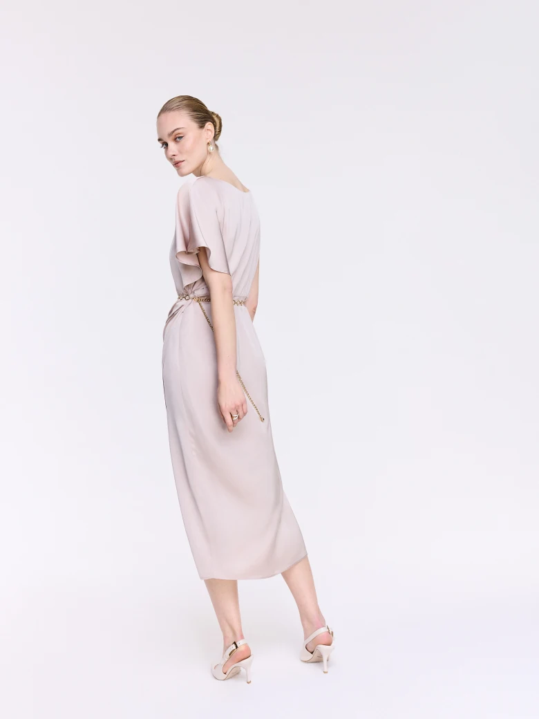A glamorous dress with an asymmetrical sleeve