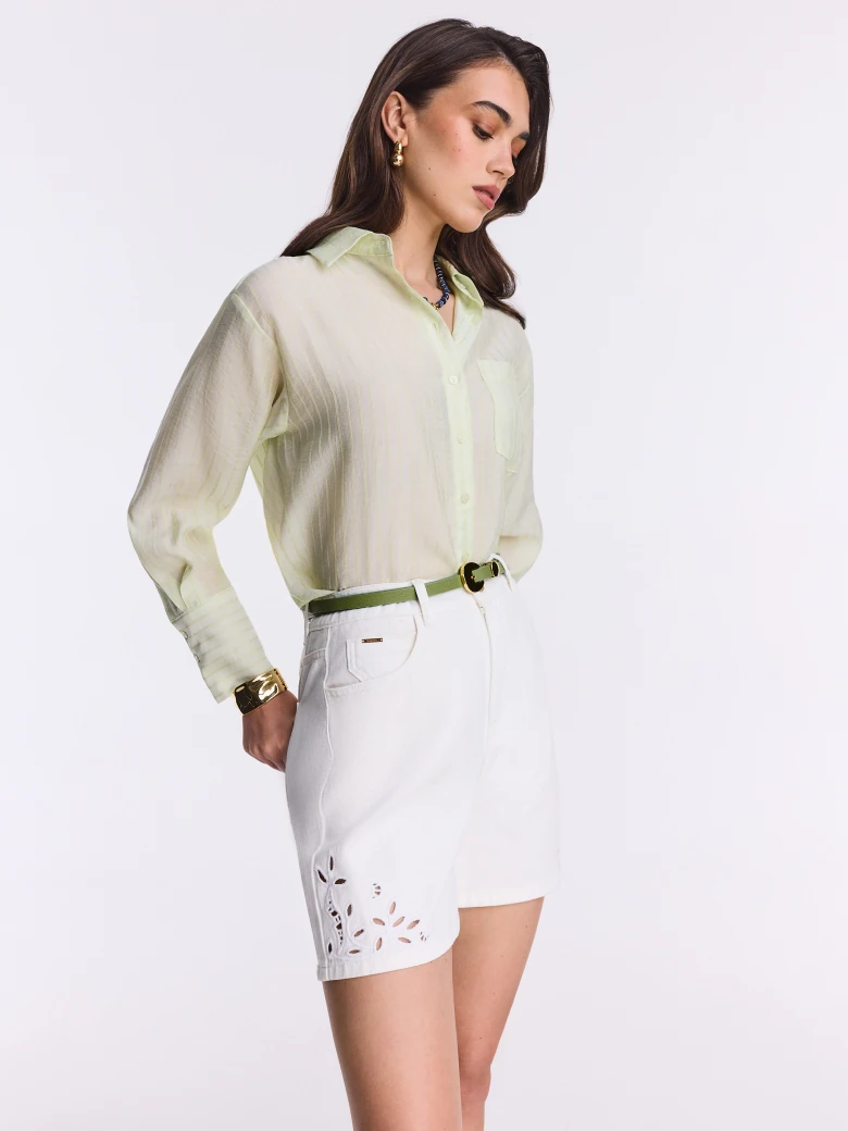Short white denim pants with openwork decoration