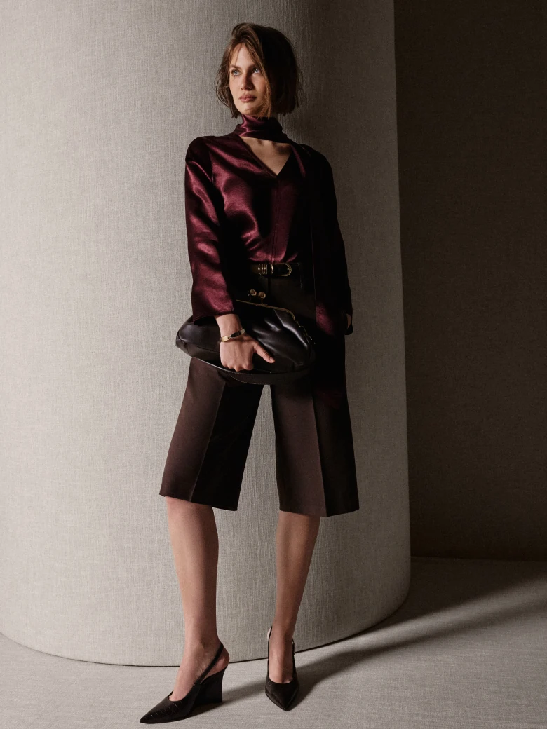 An elegant burgundy blouse with a sash