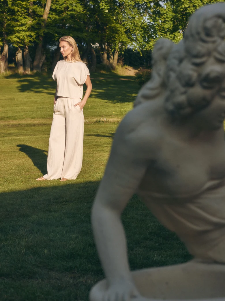 Loose-fitting beige trousers