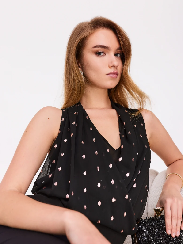 Black sleeveless blouse with fine pattern