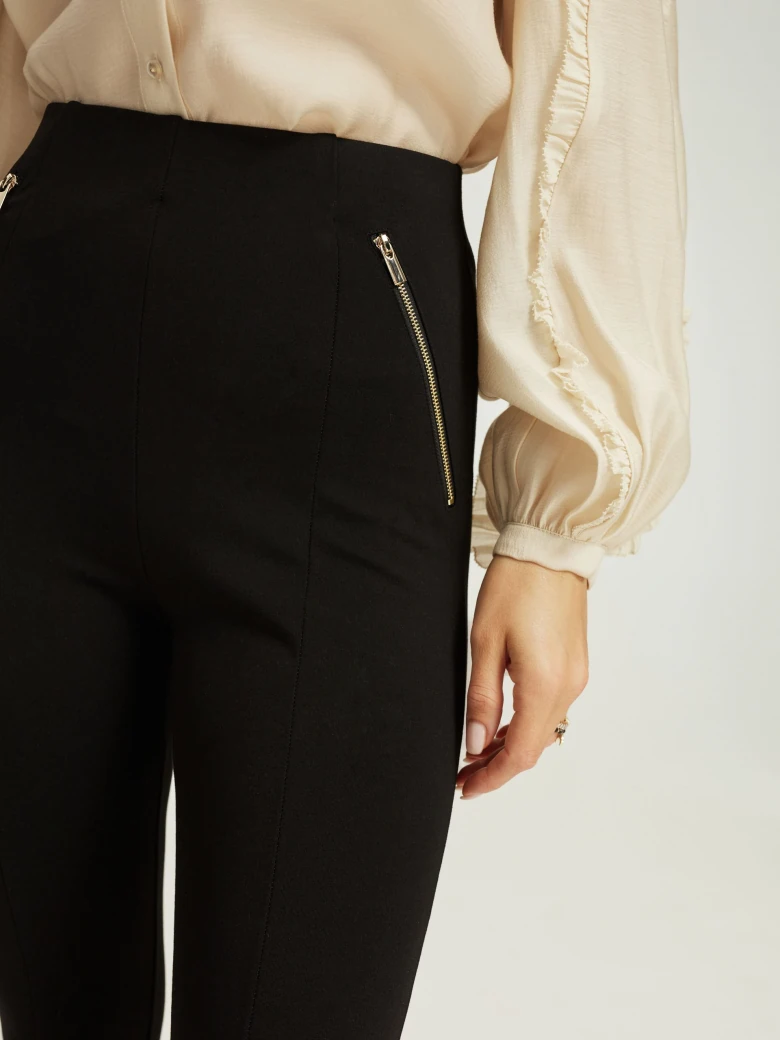 Black fitted pants with zippers
