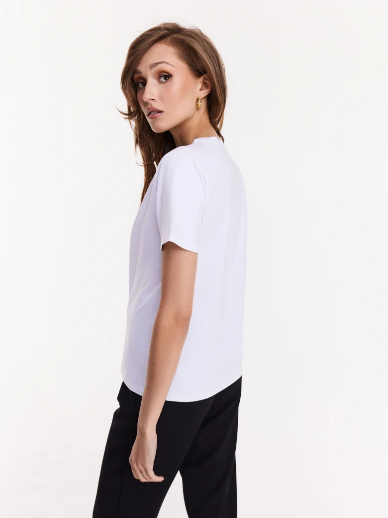 White blouse with short sleeves and decorative patch