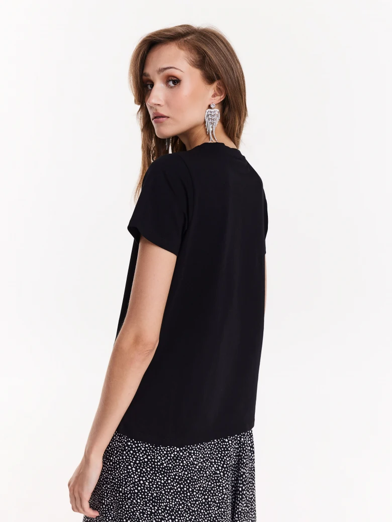 Black blouse with short sleeves and decorative patch