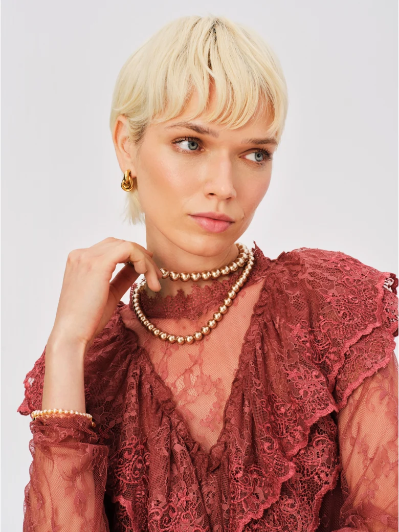 Lace blouse with brick-colored embellishments