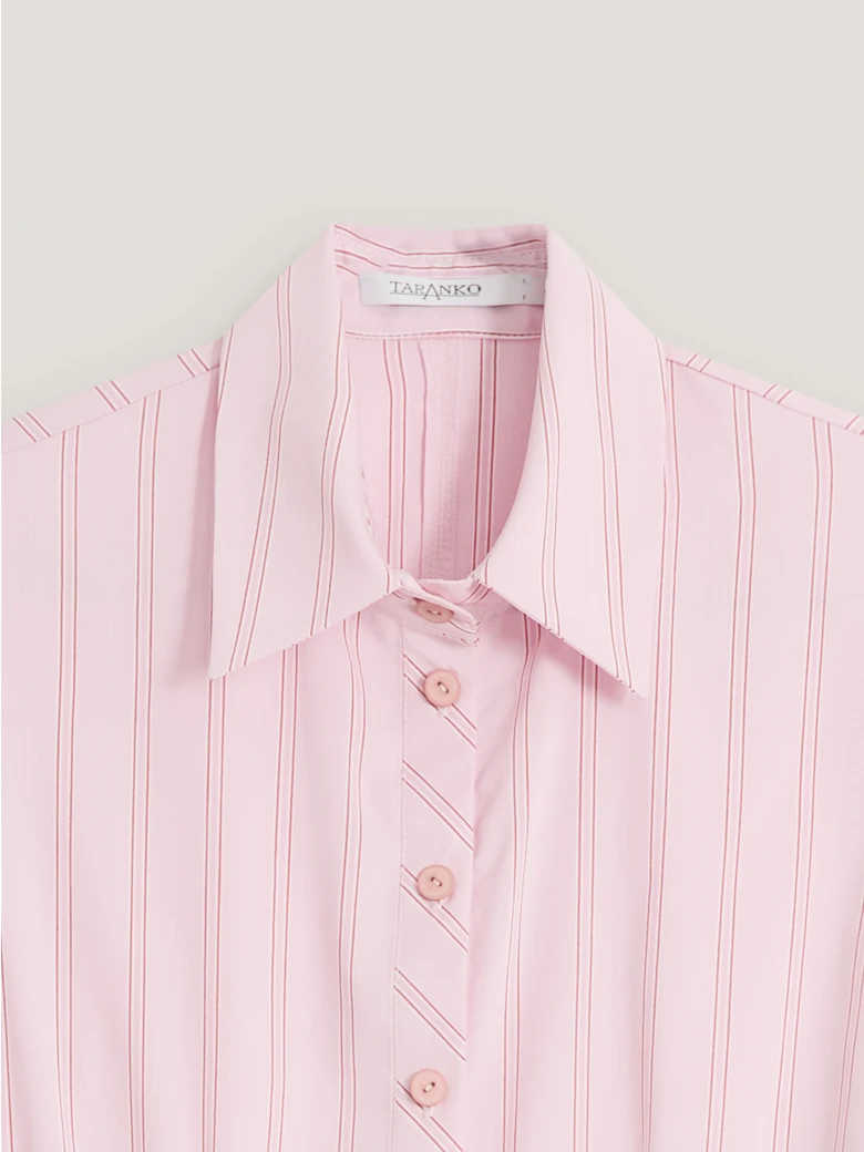A light pink, fitted, ribbed blouse