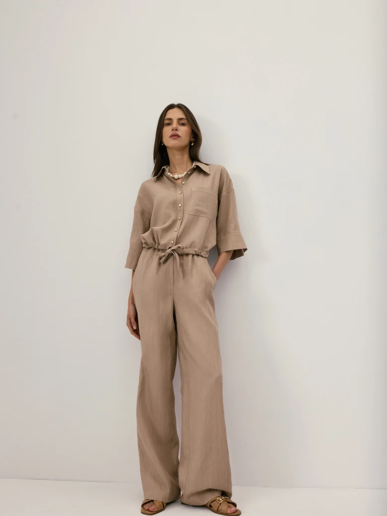 Beige high-waisted trousers with a subtle ribbed pattern
