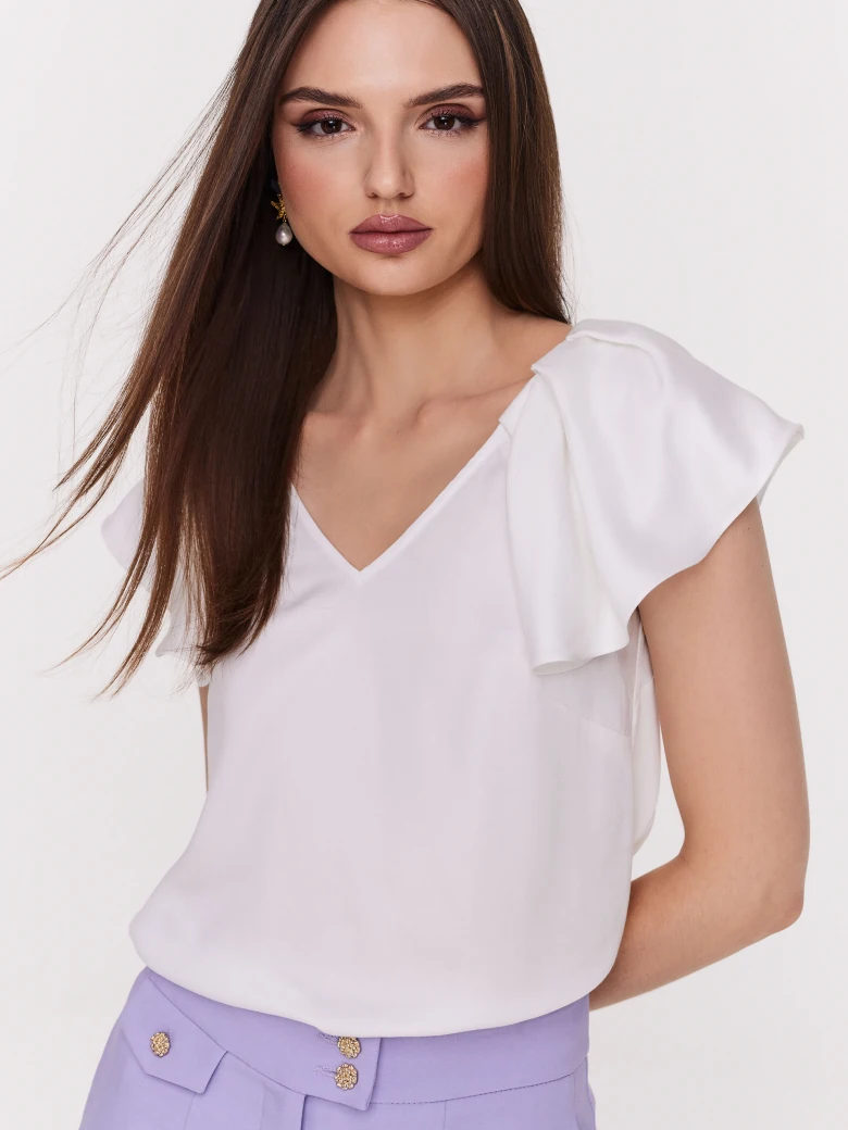 Loose white blouse with ruffle