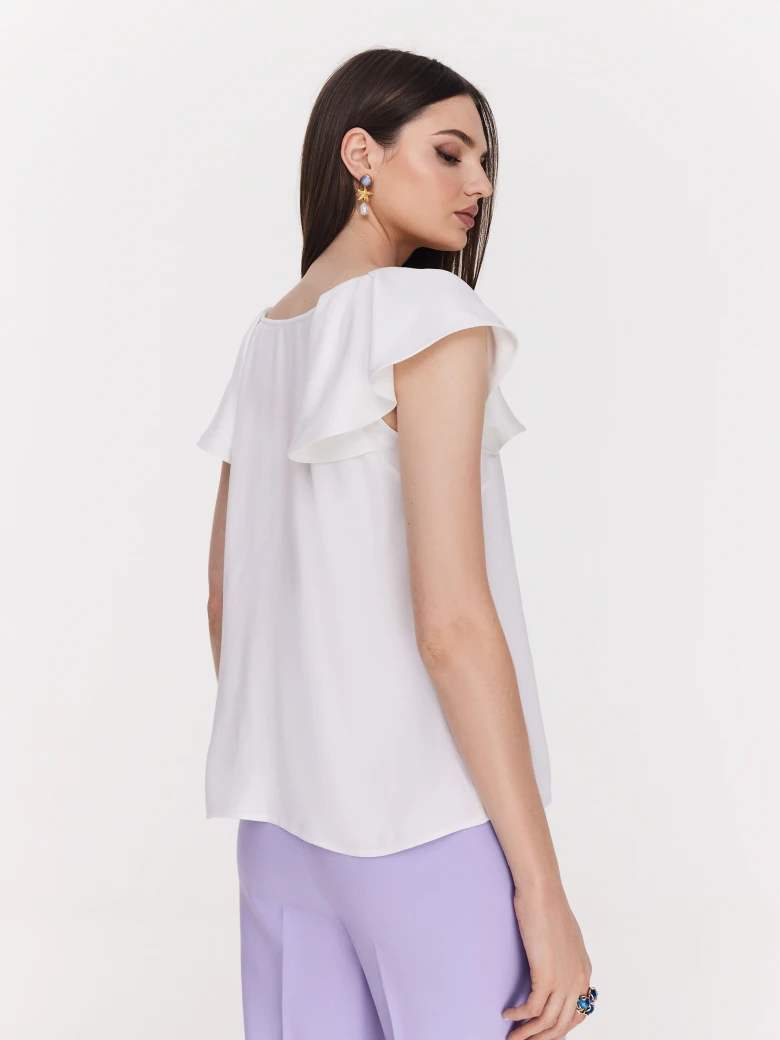 Loose white blouse with ruffle