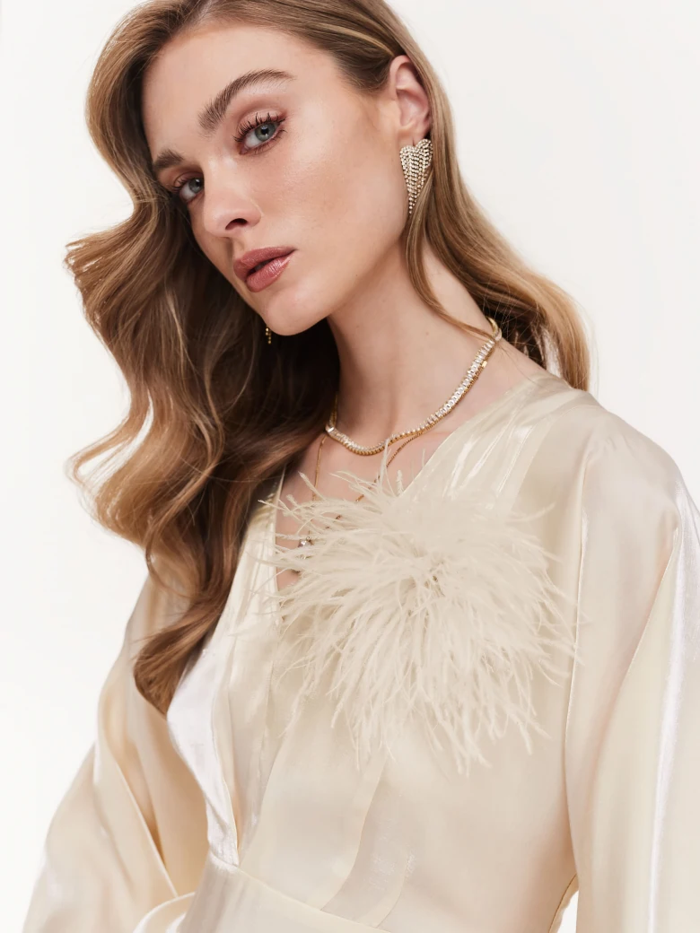 Cream brooch with feathers