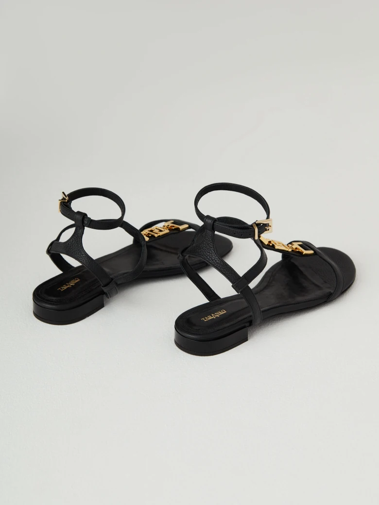 Black leather sandals with gold elements
