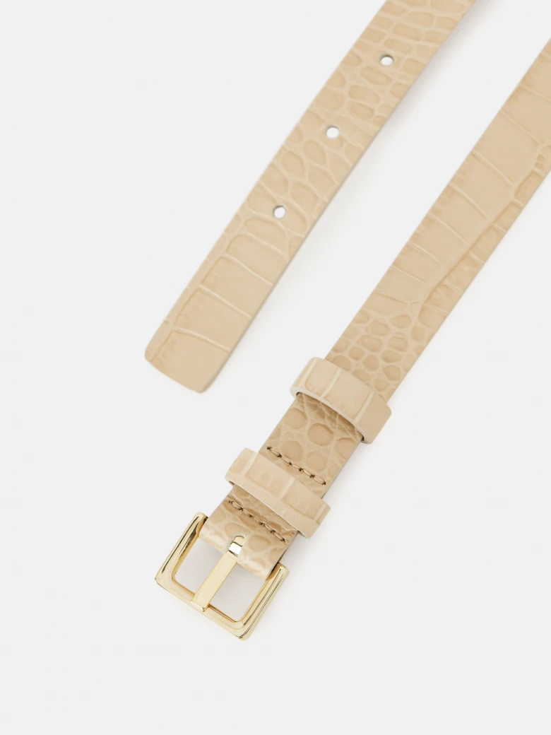 Narrow beige belt with crocodile leather texture