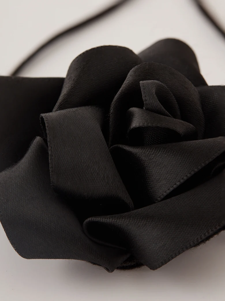Black rose necklace on a thong