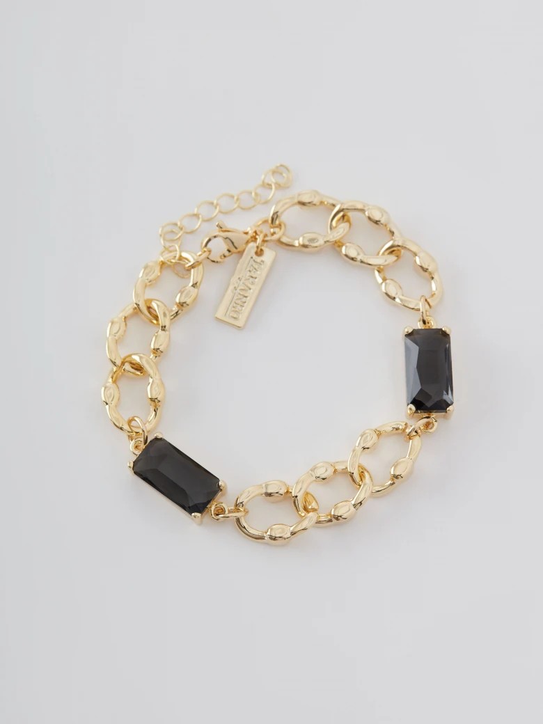 Gold color bracelet with glass stone