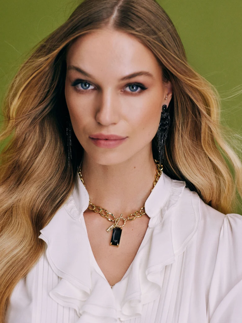 Gold colored necklace with glass pendant