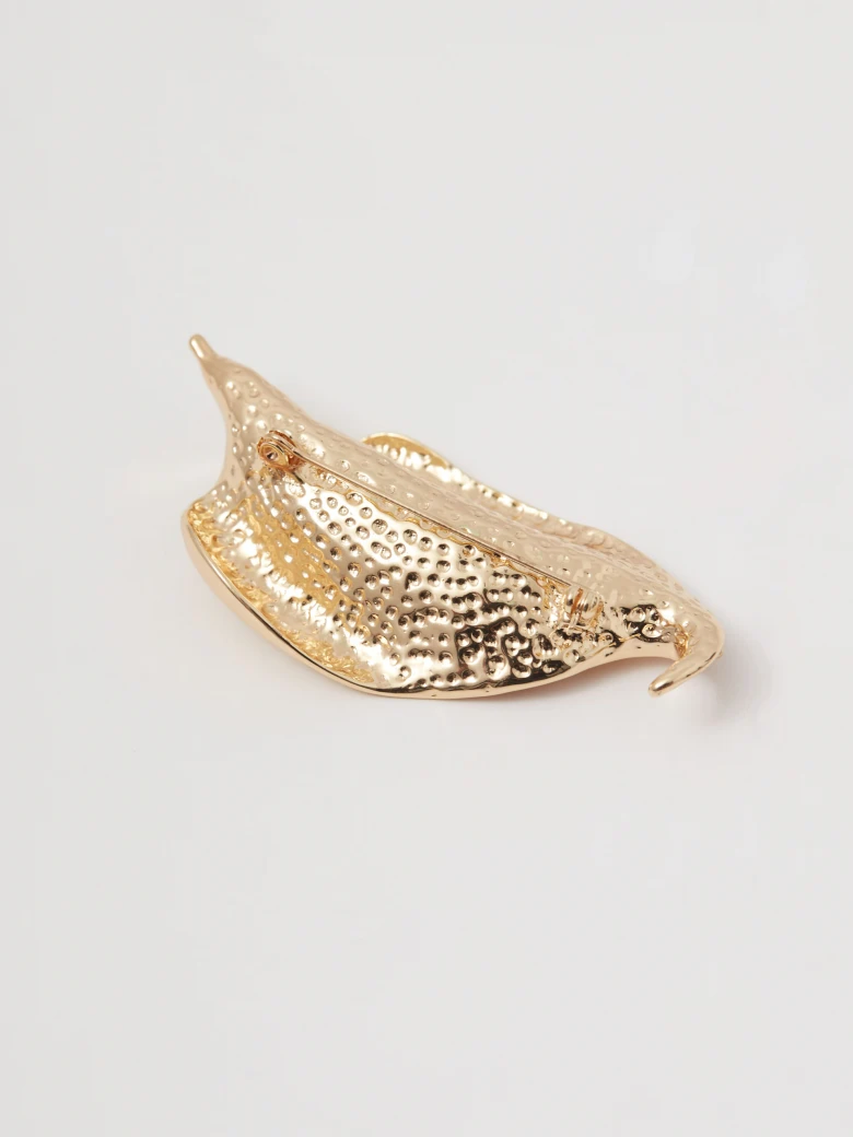 Gold-colored leaf-shaped brooch
