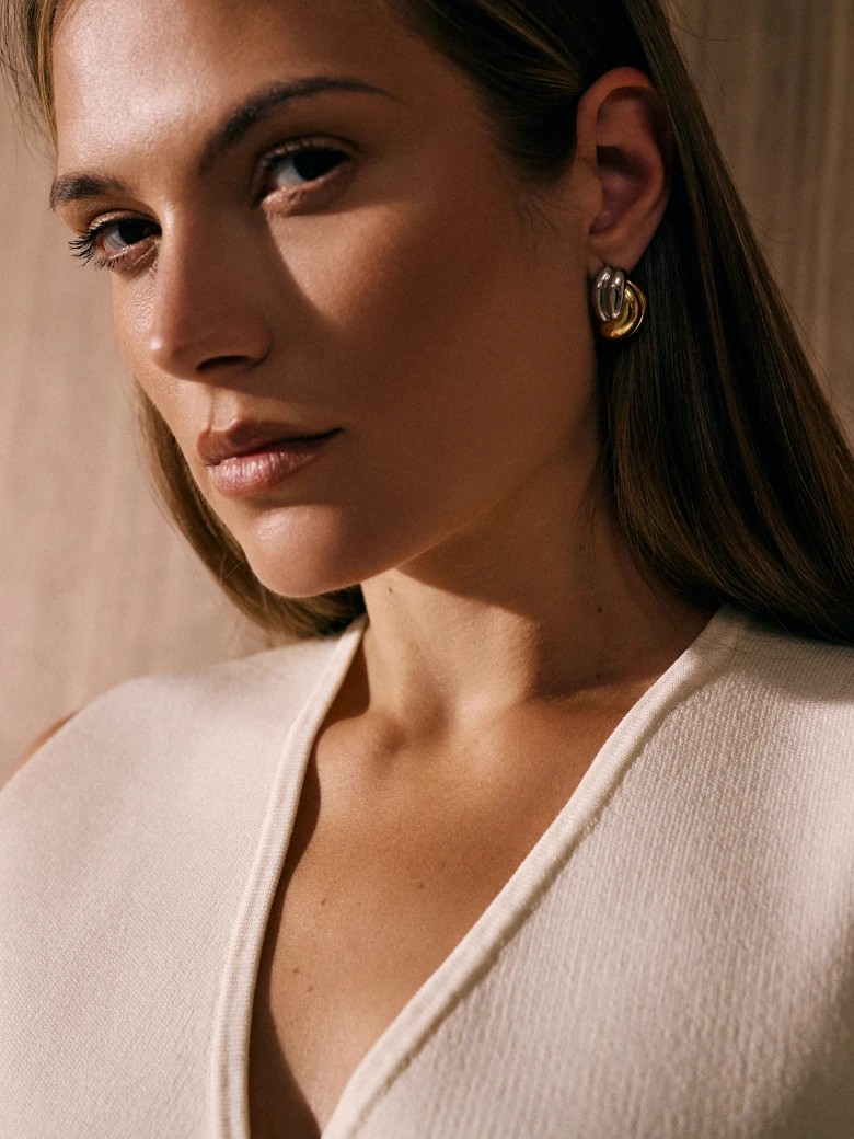Gold and silver knot-shaped earrings