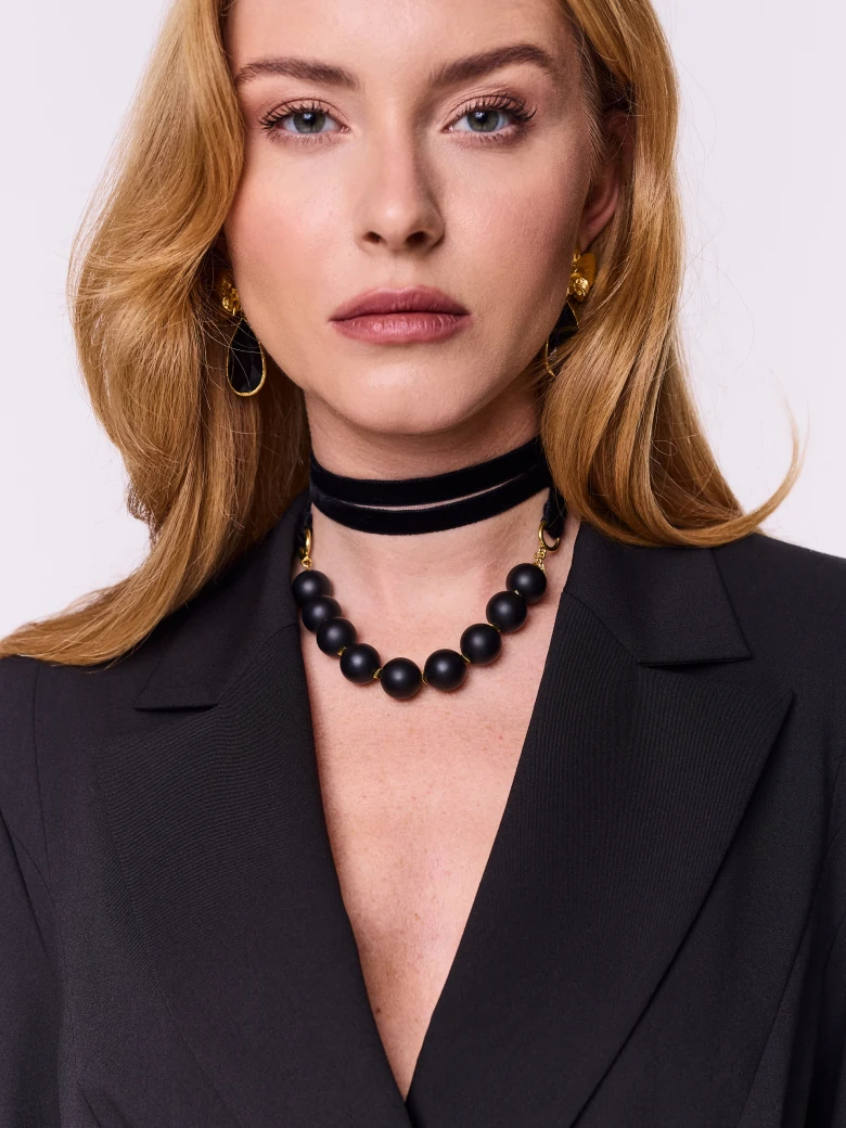 Gold-plated necklace with onyx and hematite stones on a ribbon