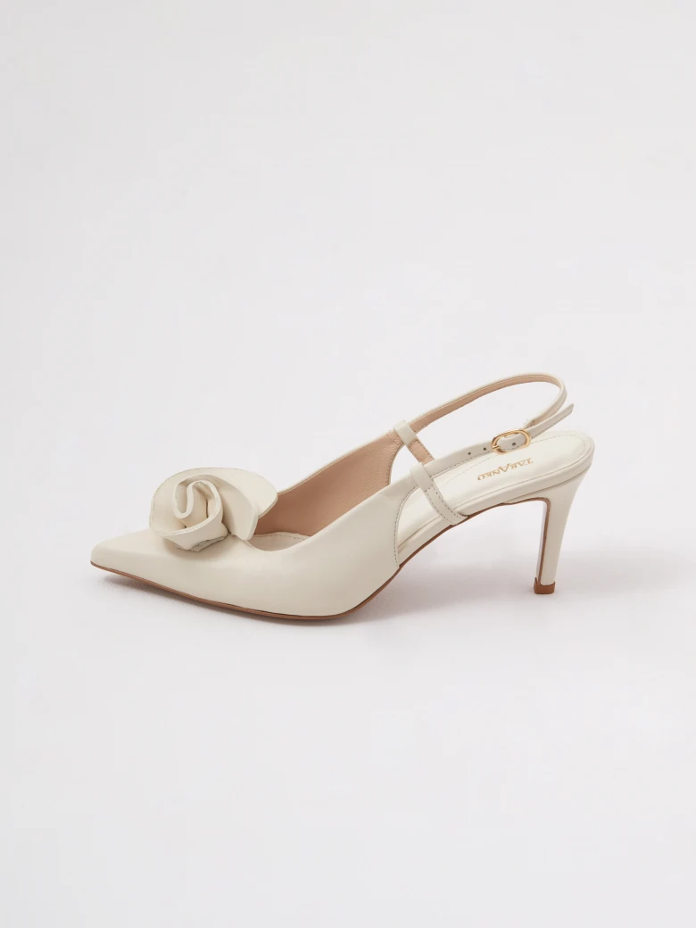 Cream-colored leather pumps with a flower