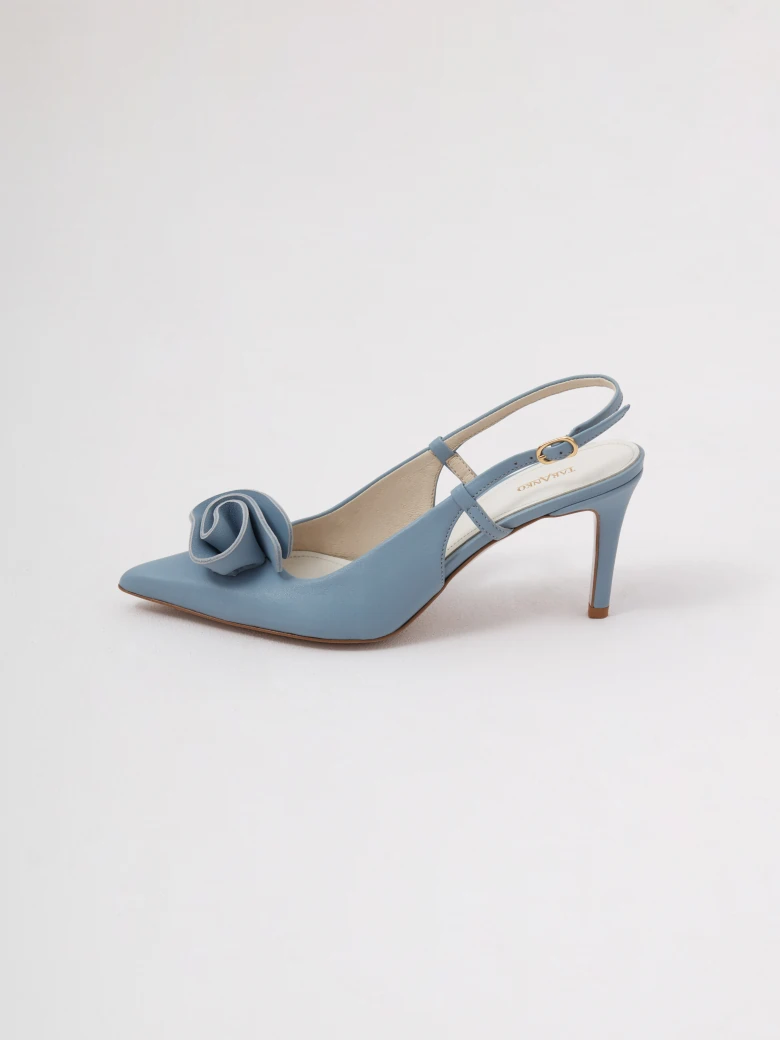Light blue leather pumps with a flower detail and an open heel