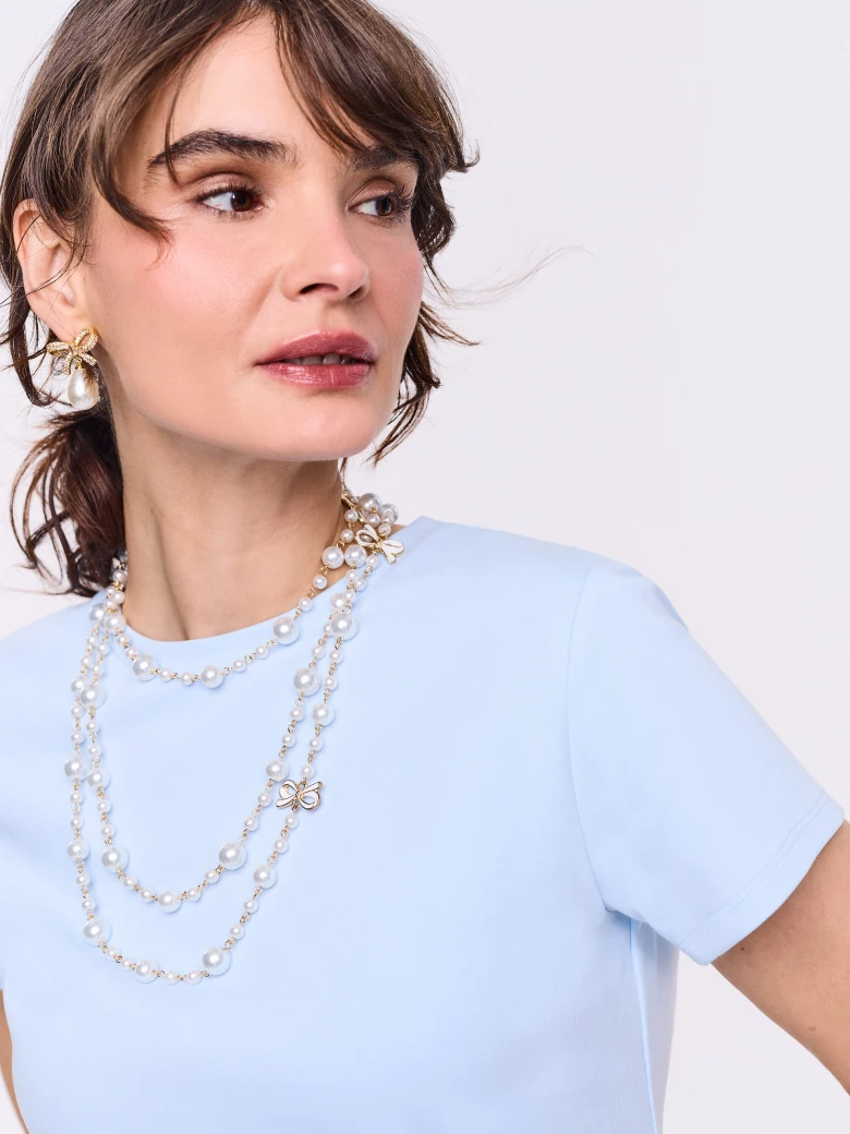 Long necklace made of glass pearls with gold-plated pendants