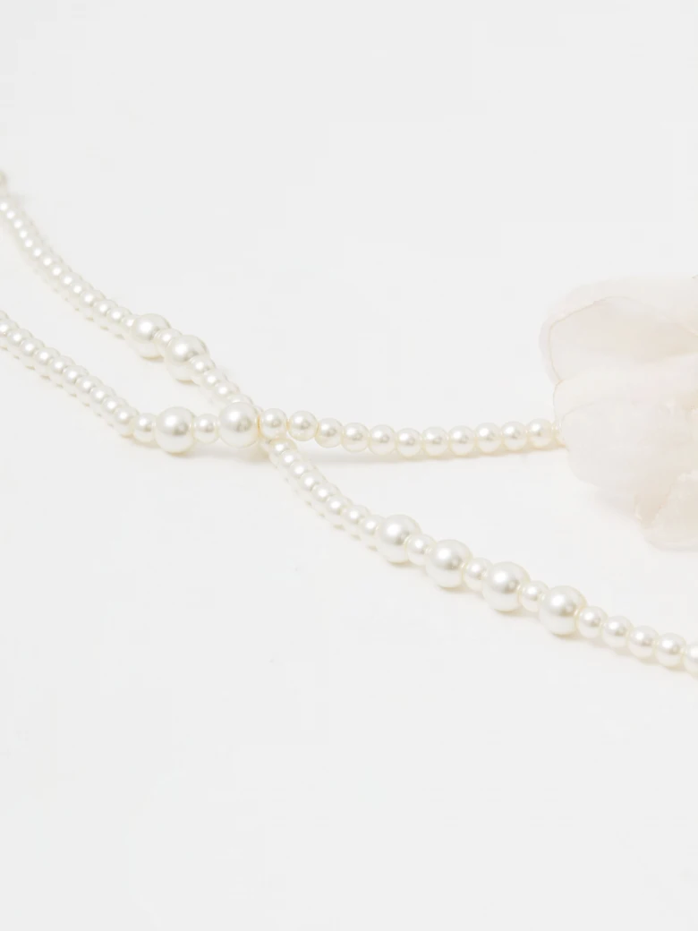 Double necklace made of glass pearls with flowers