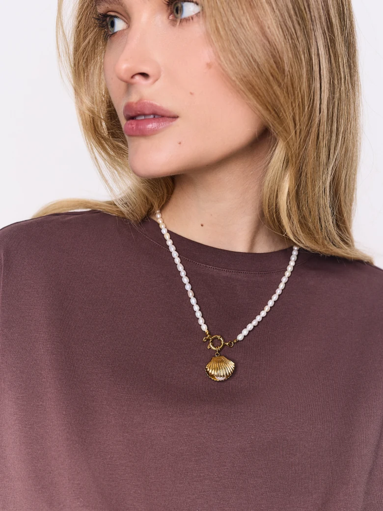A necklace made of natural pearls with a gold-plated pendant