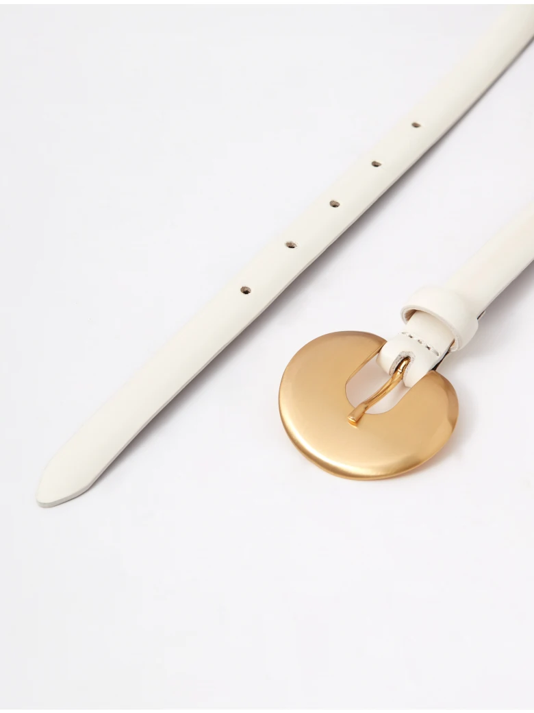 A thin, creamy-colored strap made of bombato leather