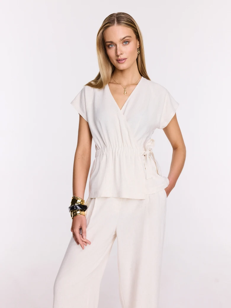 Light beige wrap blouse with a tie at the waist