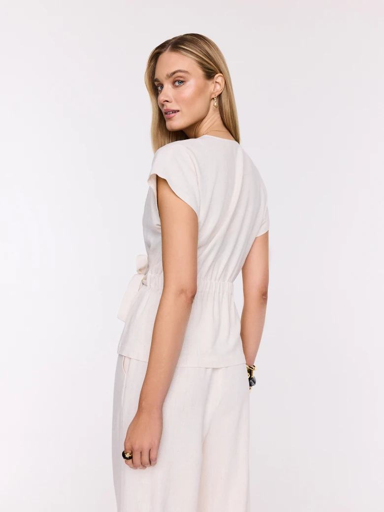Light beige wrap blouse with a tie at the waist
