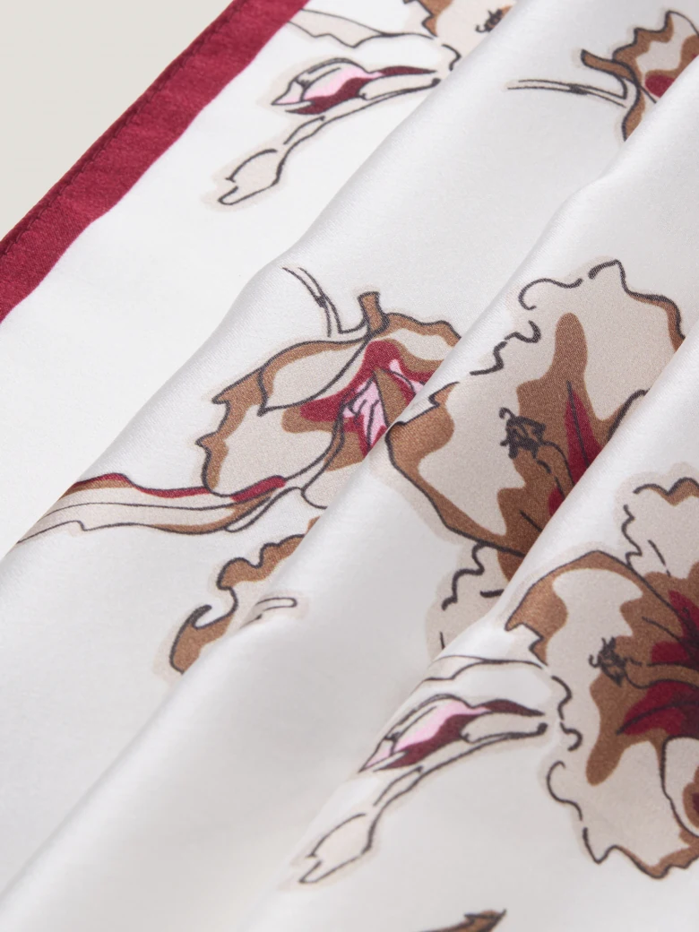 An elegant silk scarf with a floral pattern