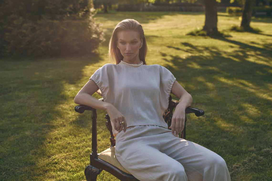A light beige blouse with a cut-out at the back