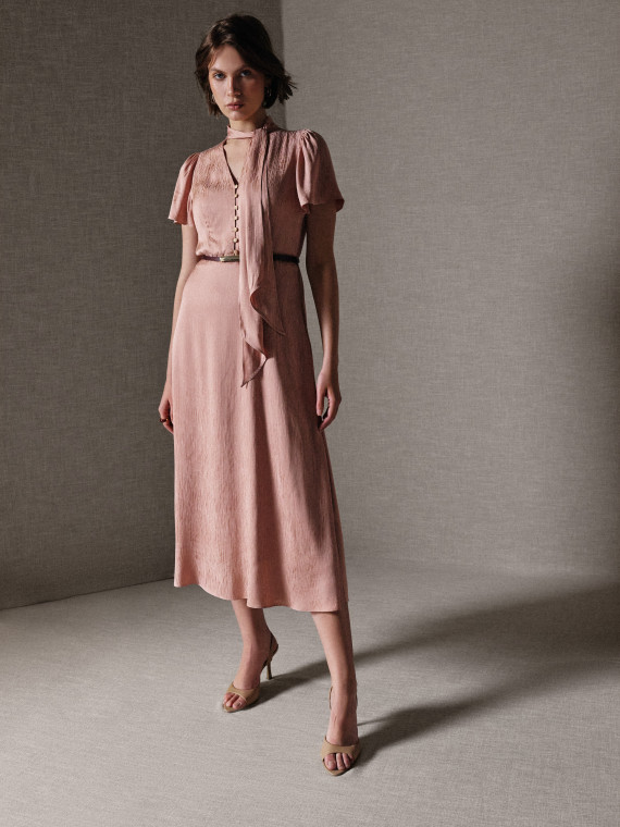 A powder-pink midi dress with a sash and buttons