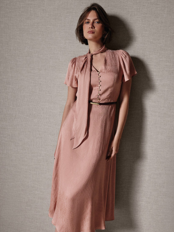 A powder-pink midi dress with a sash and buttons