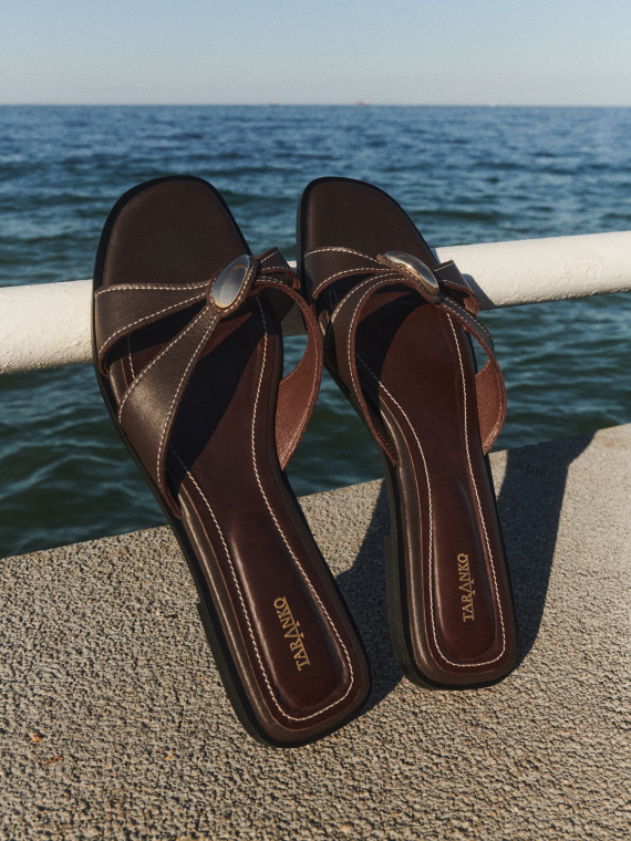 Brown leather flip-flops with decorative buckles