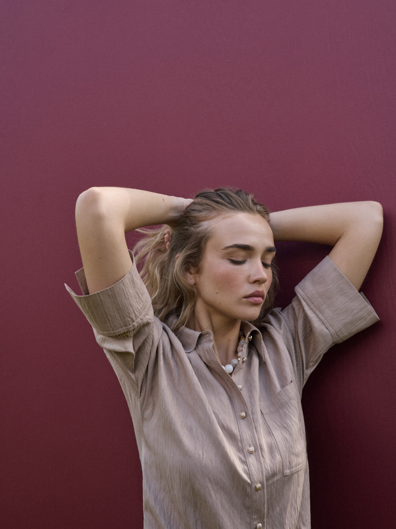 A beige short-sleeved shirt with a subtle ribbed pattern